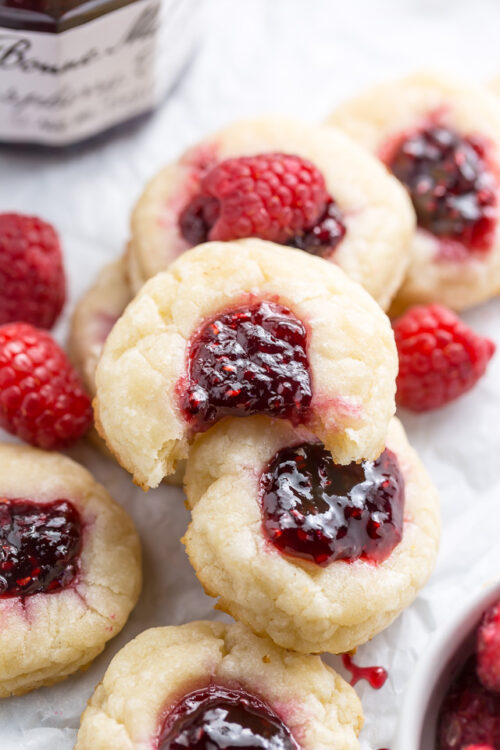 Raspberry thumbprint cookies with a bite taken out of it.