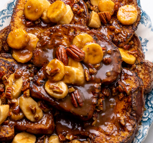 This Easy Bananas Foster French Toast is one of our favorite breakfast recipes! Crispy slices of buttery brioche are topped with a delicious homemade bananas foster sauce made from dark rum, butter, brown sugar, heavy cream, and crunchy pecans. Delicious on it's on, but devilishly good with whipped cream or vanilla ice cream!