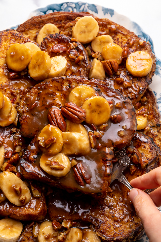 This Easy Bananas Foster French Toast is one of our favorite breakfast recipes! Crispy slices of buttery brioche are topped with a delicious homemade bananas foster sauce made from dark rum, butter, brown sugar, heavy cream, and crunchy pecans. Delicious on it's on, but devilishly good with whipped cream or vanilla ice cream!